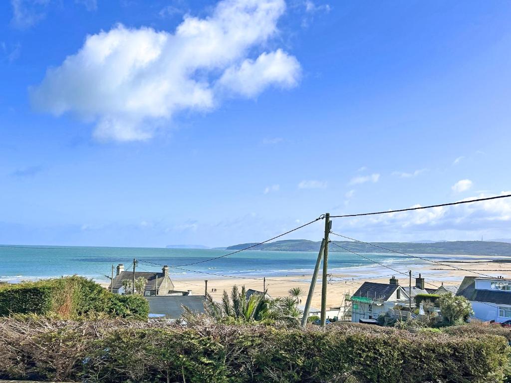 a view of a beach with houses and the ocean at The Holiday House in Benllech