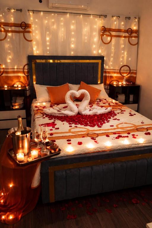 a bedroom with a bed with candles and lights at Colinas del Sol Res perfect in Jacagua