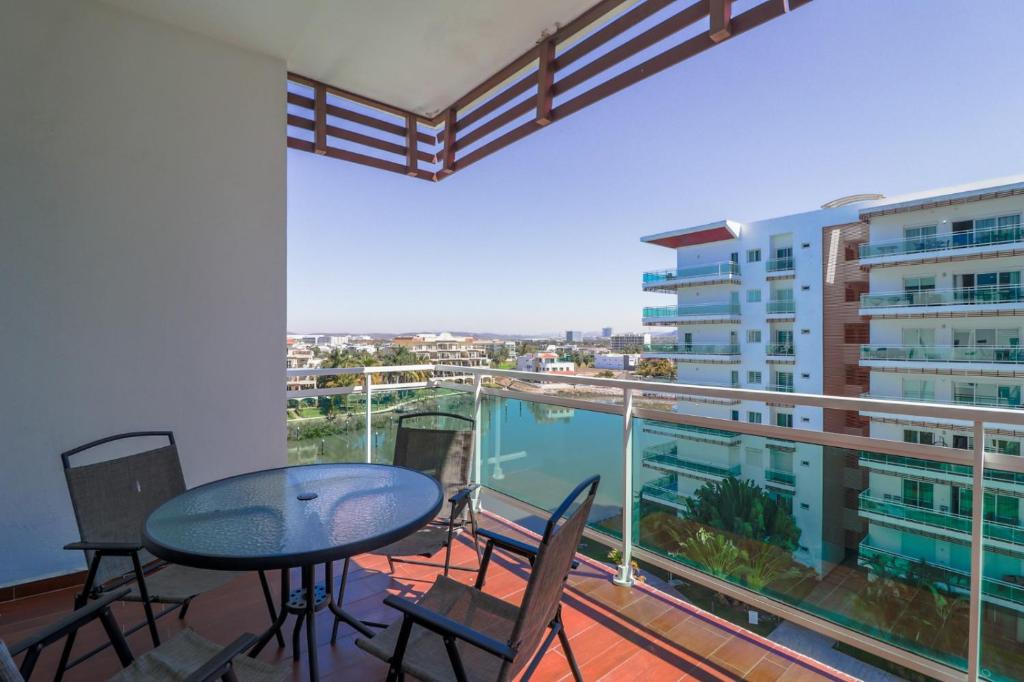 a balcony with a table and chairs and a view of a building at Pacifika in Mazatlán