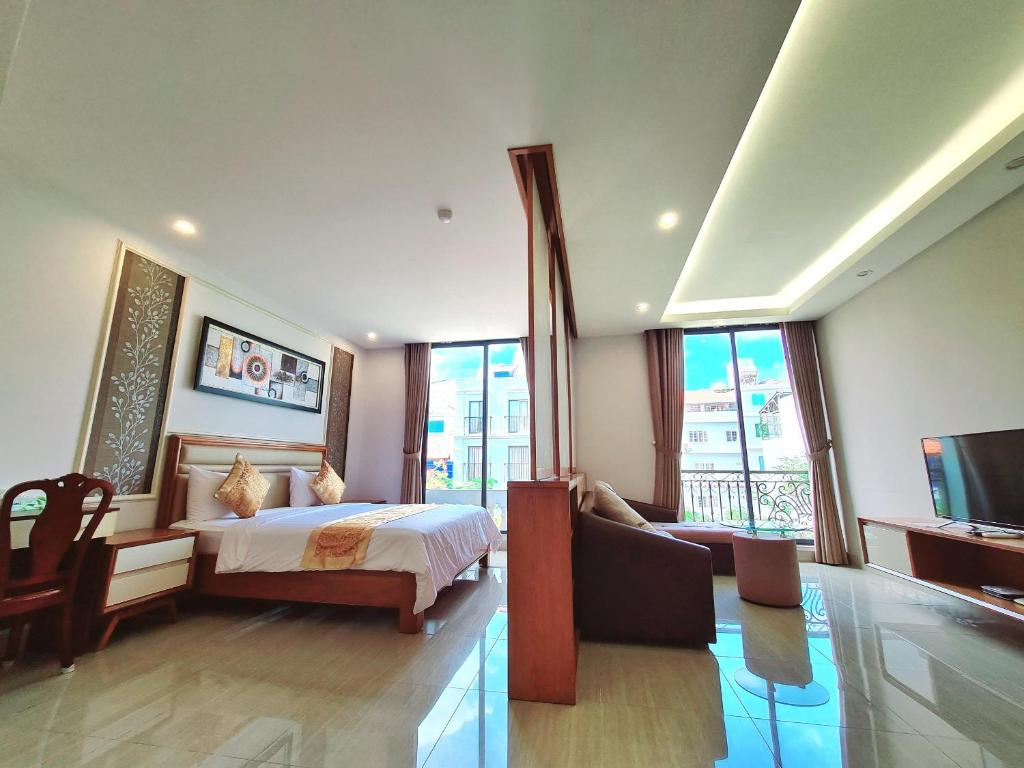 a bedroom with a bed and a tv in a room at GreenStay Hotel & Apartment in Ho Chi Minh City