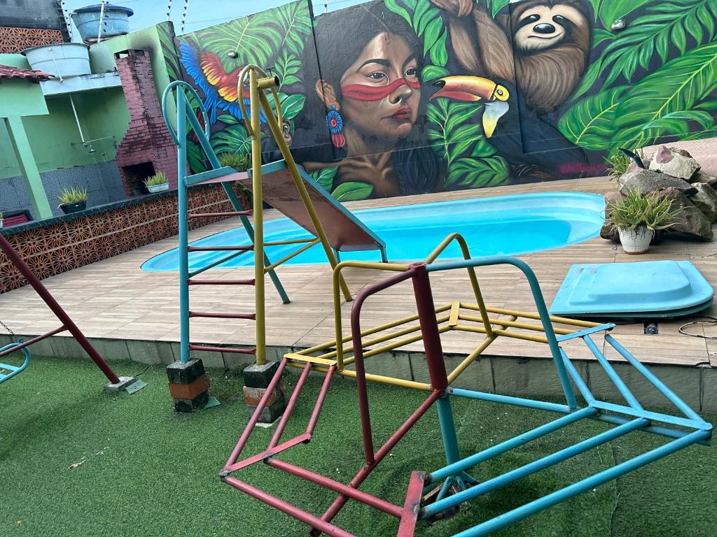 a group of chairs sitting in front of a pool at Espaço festa Angini in Manaus