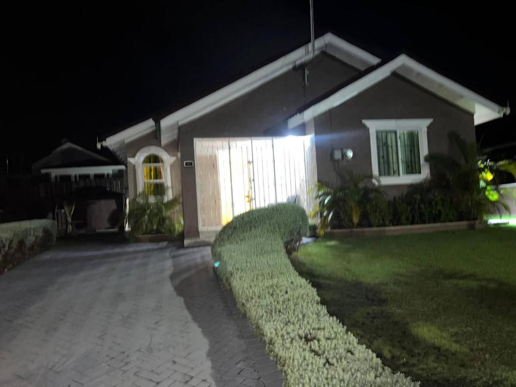 a house at night with a driveway at Serenity Vacation Villa in Ocho Rios
