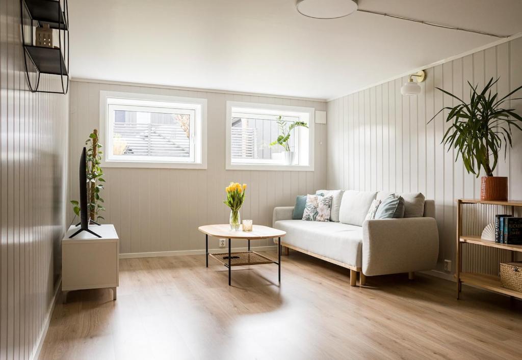 a living room with a couch and a table at Cozy apartment in Sola