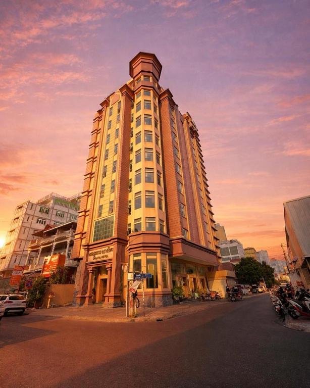 a tall building on the corner of a street at Salita Hotel Phnom Penh in Phnom Penh