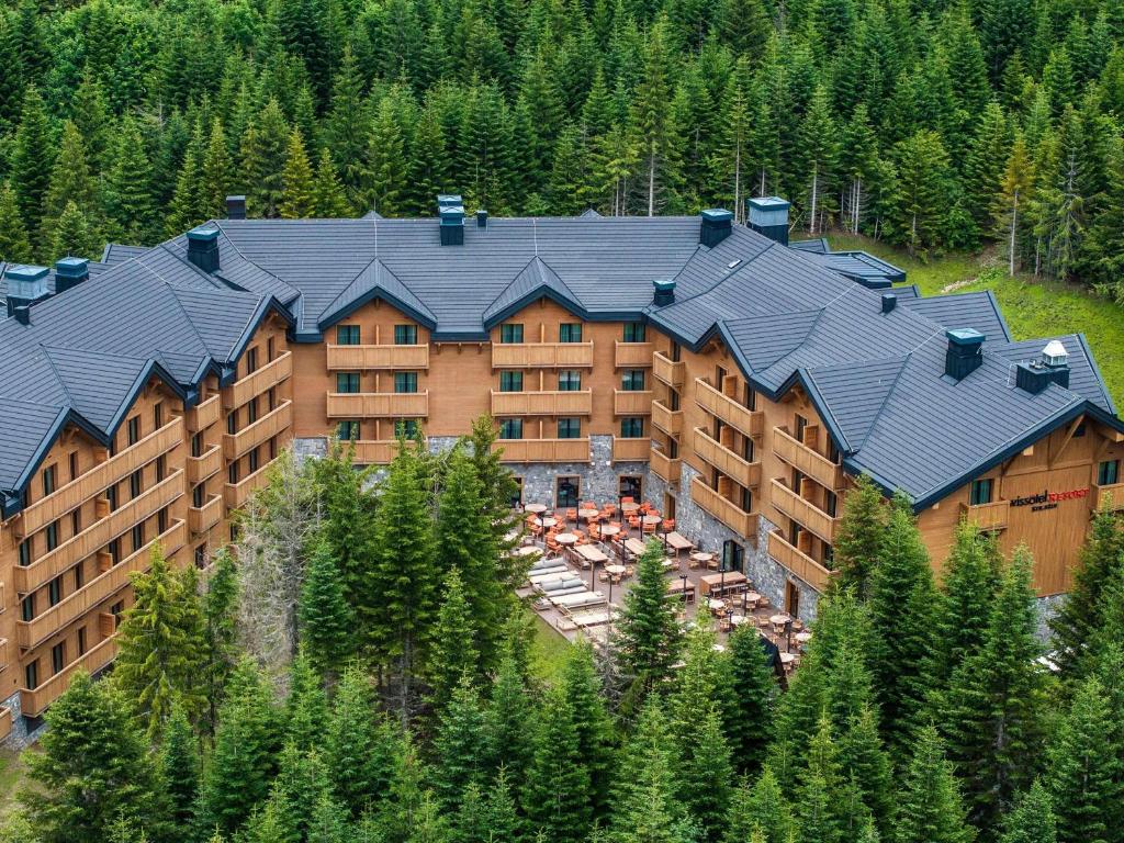 an aerial view of a large building with trees at Swissôtel Resort Kolasin in Kolašin