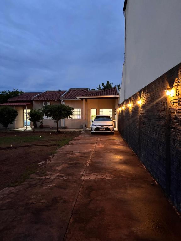 a car parked in front of a house at night at Pousada Bem-Te-Vi in Rondonópolis