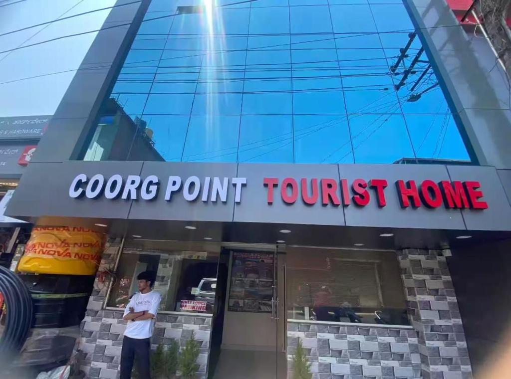 a man standing in front of a restaurant at Coorg point in Madikeri