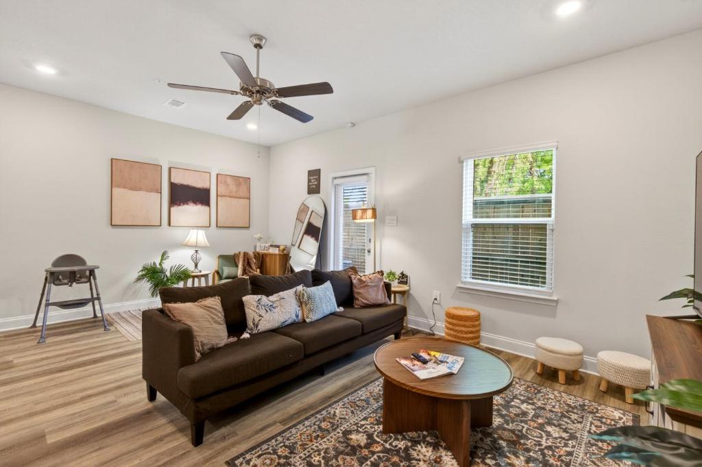 a living room with a couch and a table at Biloxi Coastal Haven Walk to Beach in Biloxi