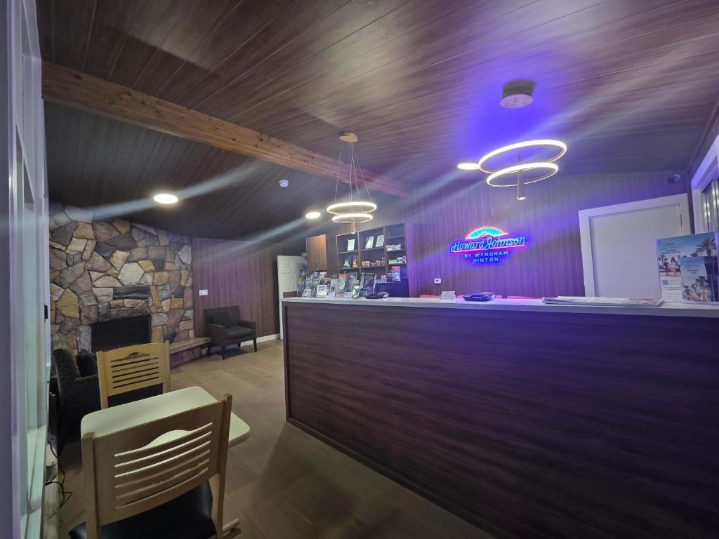 a bar in a restaurant with a stone fireplace at Howard Johnson by Wyndham Hinton in Hinton