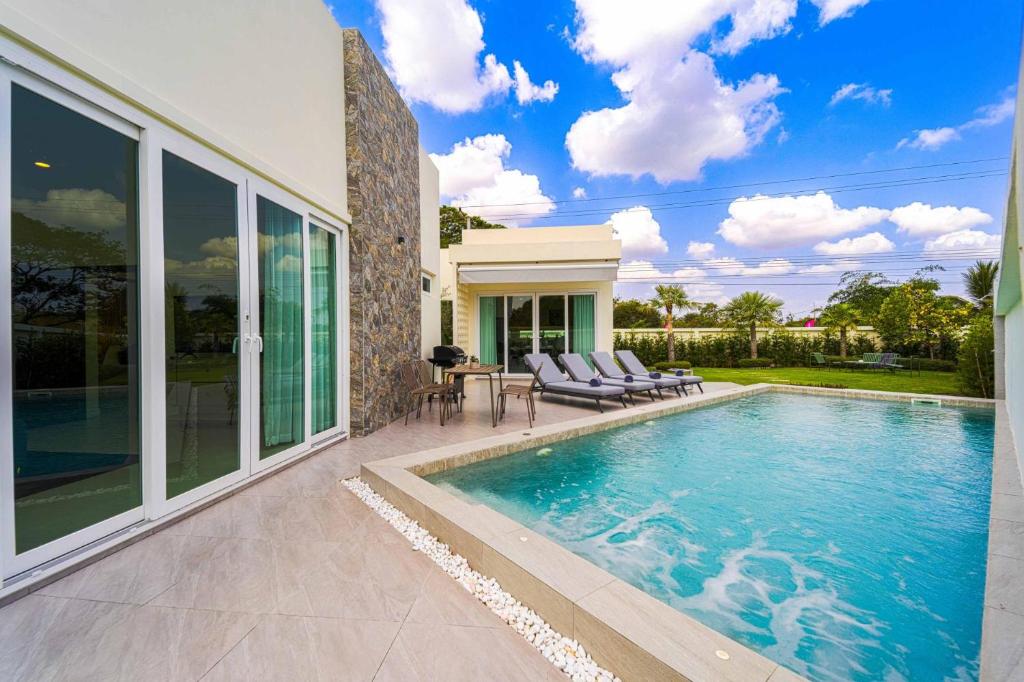 a house with a swimming pool in a yard at 3BR Luxury Pool Villa, Hua Hin (TP3) in Hua Hin