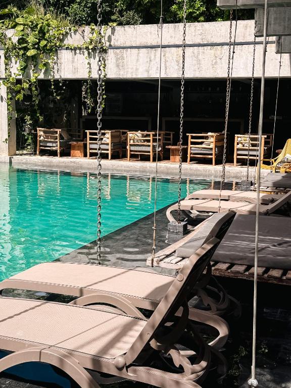 a group of swings in a swimming pool at Hotel Makaabá Eco-Boutique in Bacalar
