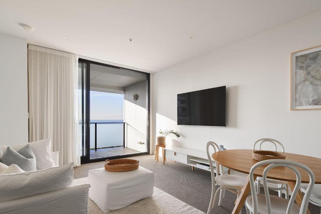 a living room with a table and a couch at The Calm in Newcastle