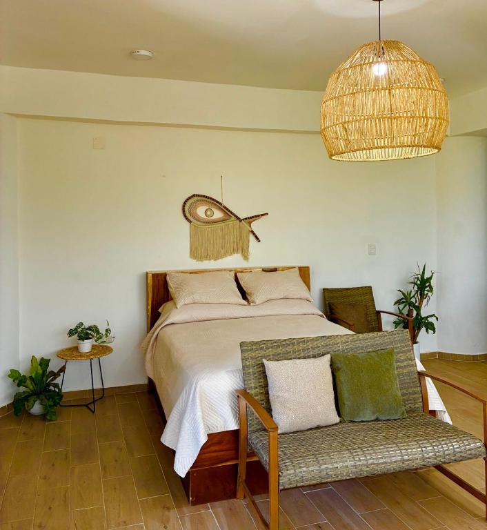 a bedroom with a bed with a fish on the wall at Coral Loft in Antón Lizardo