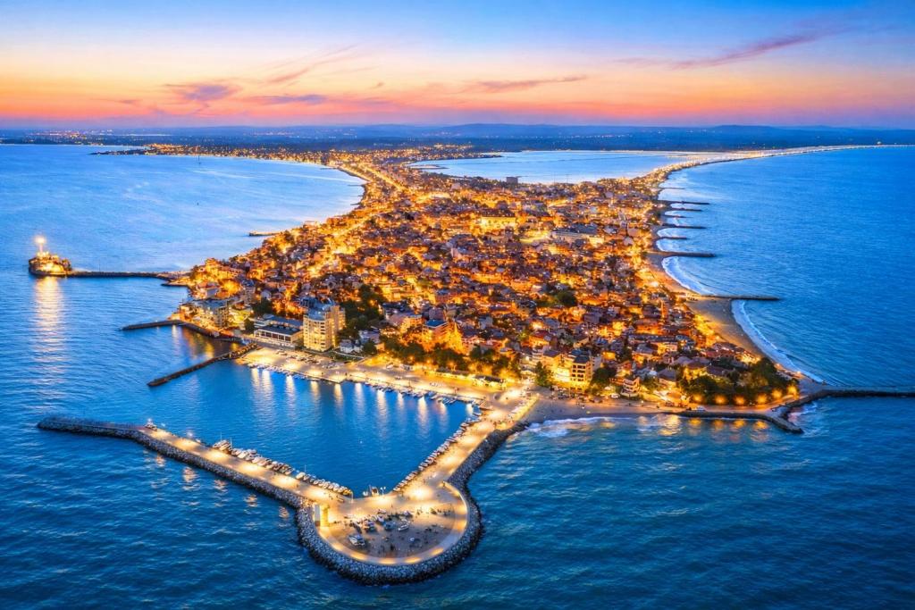 an aerial view of an island in the ocean at night at Pomorie Sea&History Residence in Pomorie
