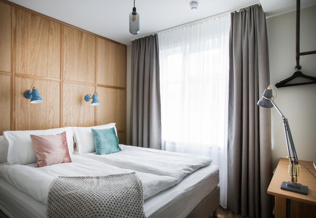 a hotel room with a bed and a window at Ódinsvé Hotel Apartments in Reykjavík