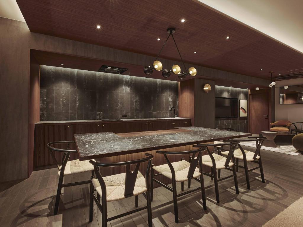 a dining room with a large table and chairs at illi Gran Azabujuban in Tokyo