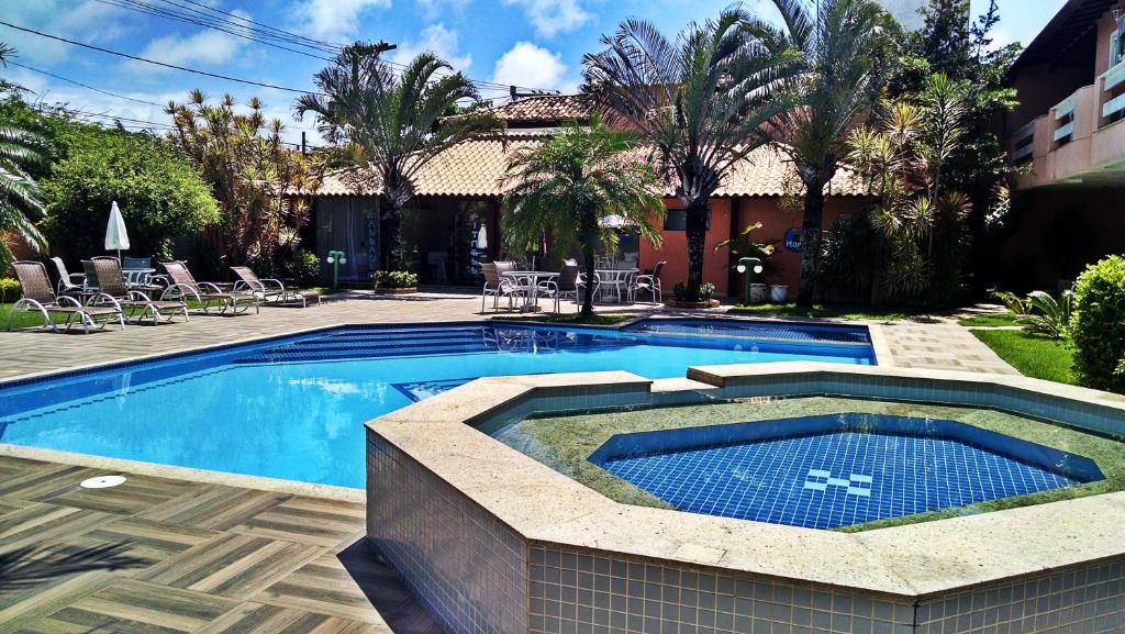 a swimming pool in front of a house at Pousada Marbella in Búzios