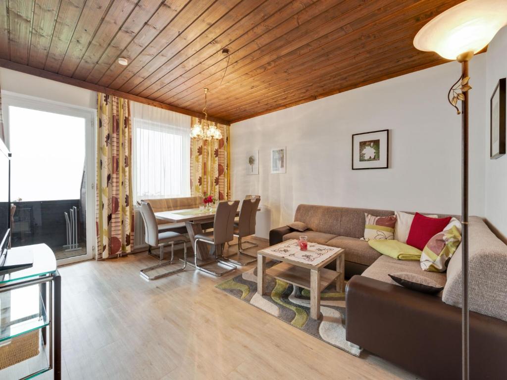 a living room with a couch and a table at Apartment in Afritz near Ski Resorts in Afritz