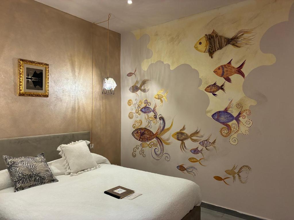 a bedroom with a bed with a painting on the wall at Affittacamere La Risacca in La Spezia