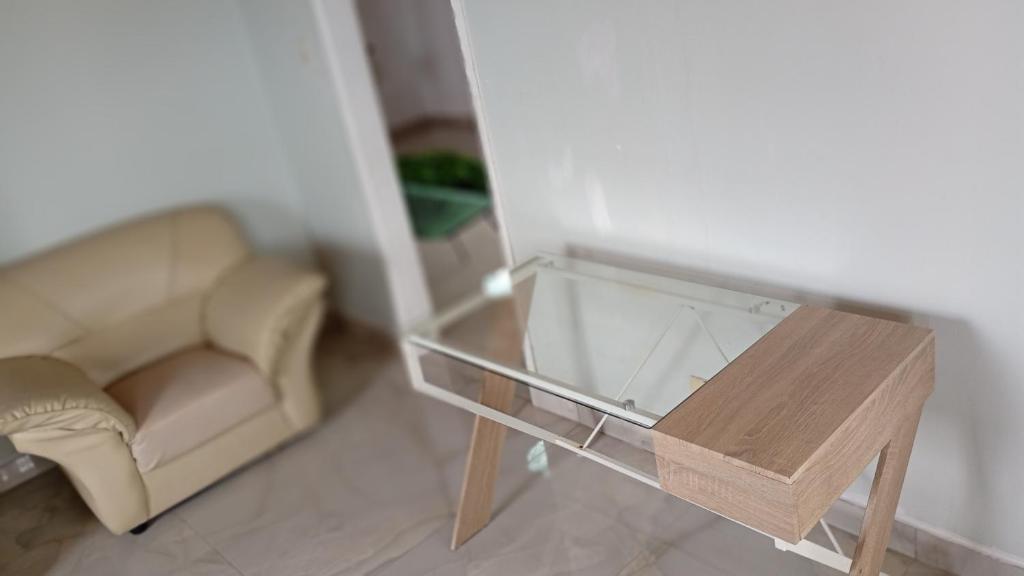 a living room with a glass table and a couch at Leisure Seaview House in Port Edward