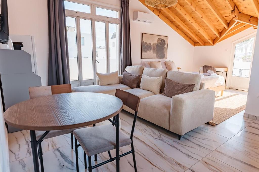 a living room with a couch and a table at Modern Studio Loft in Central Larnaca with WiFi in Larnaca