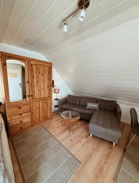 a living room with a couch and a table at Appartment, Ferienwohnung auf Fehmarn in Fehmarn