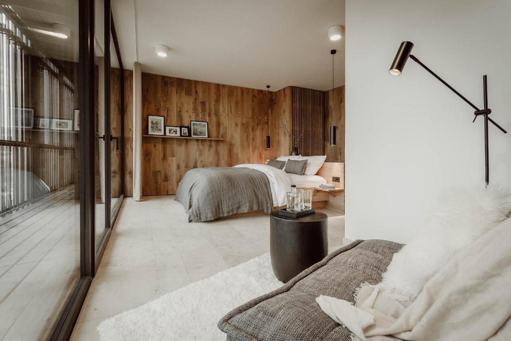 a bedroom with a bed and a living room at Naturhotel Die Maise in Hayingen