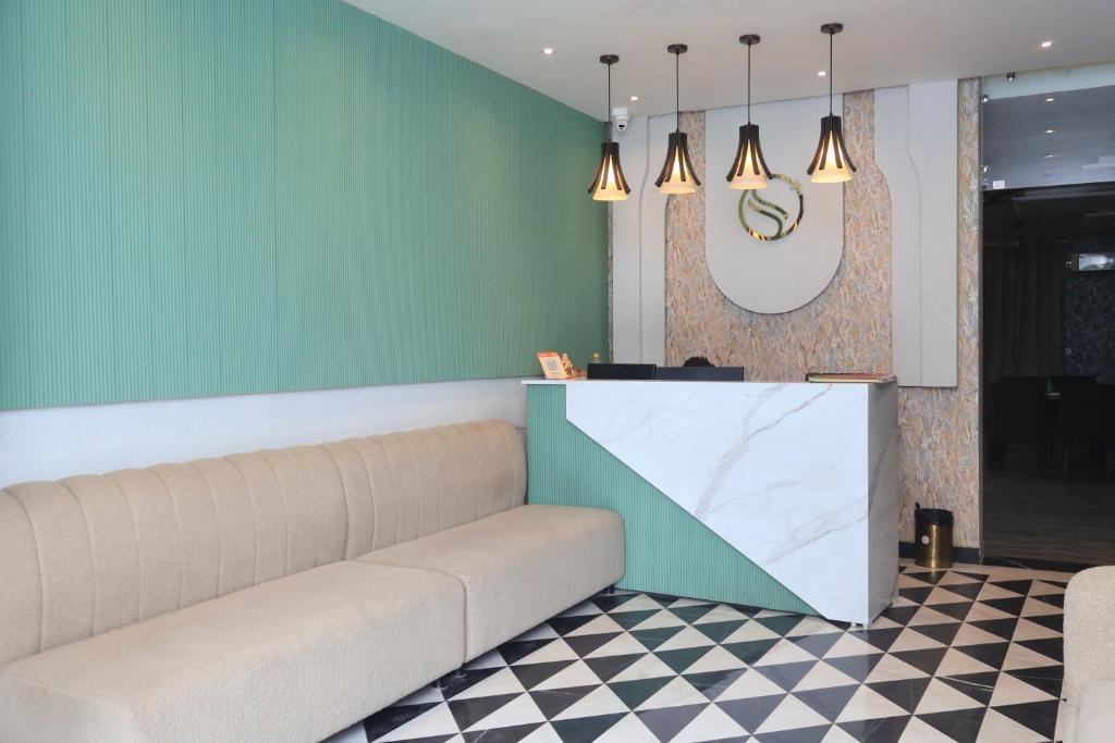 a waiting room with a couch and a counter at Serenity By The Ganges in Haridwār