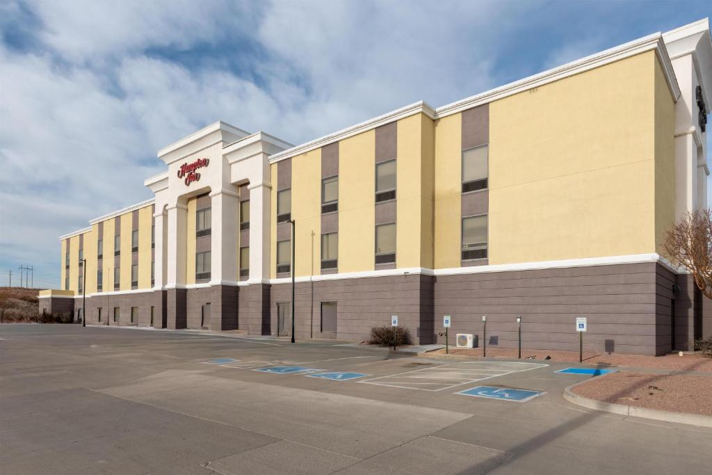 a large office building with a parking lot at Hampton Inn La Junta in La Junta