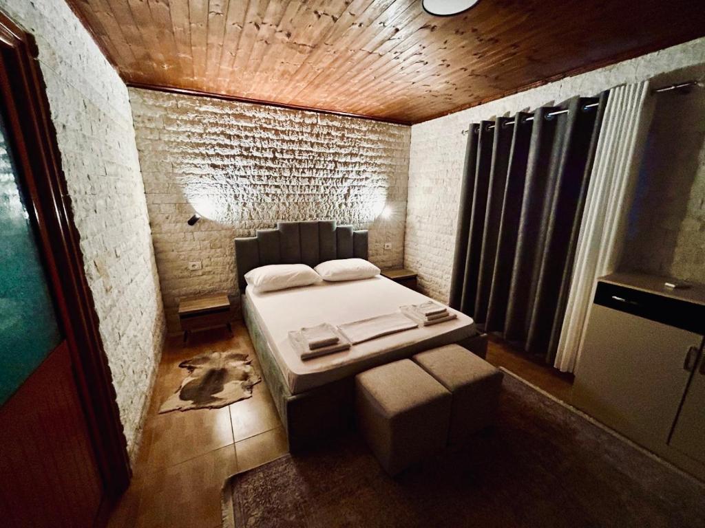 a small bedroom with a bed and a window at Siera Home in Berat