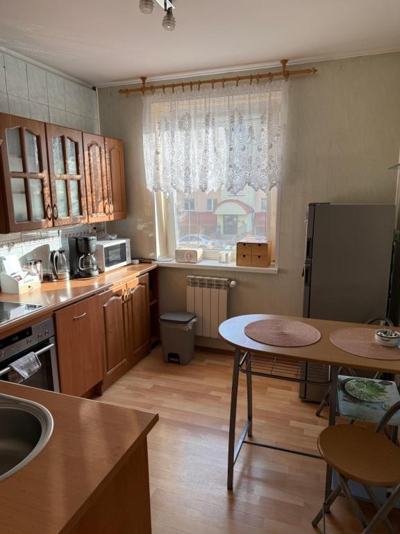 a kitchen with a table and a counter top at Apartament Aria in Ełk