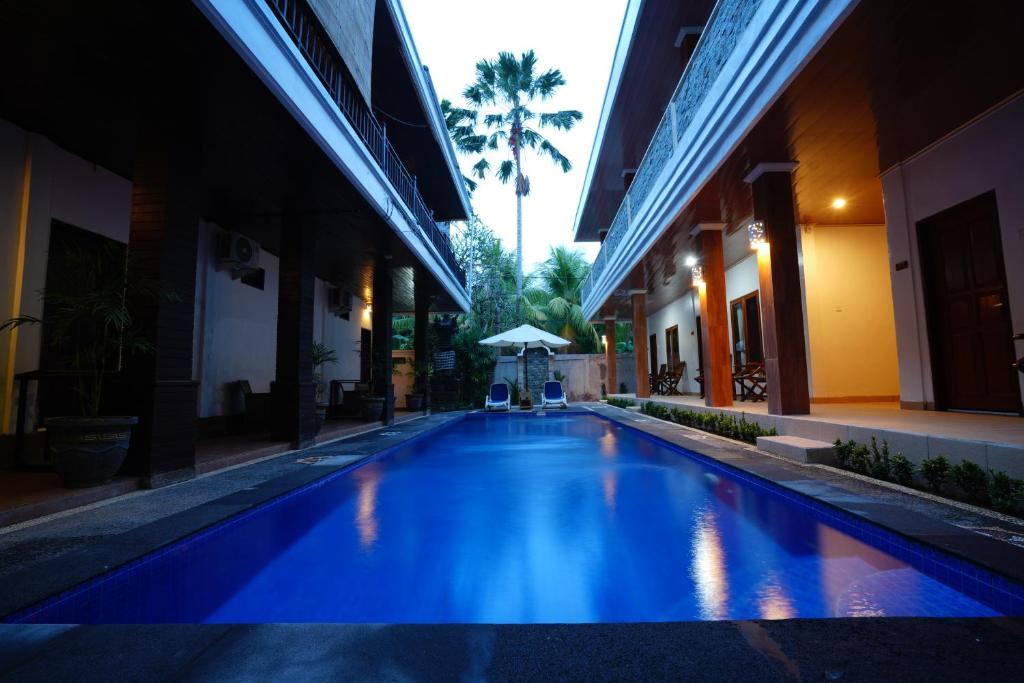 a swimming pool in the middle of a building at The Galuh Pekutatan in Pulukan