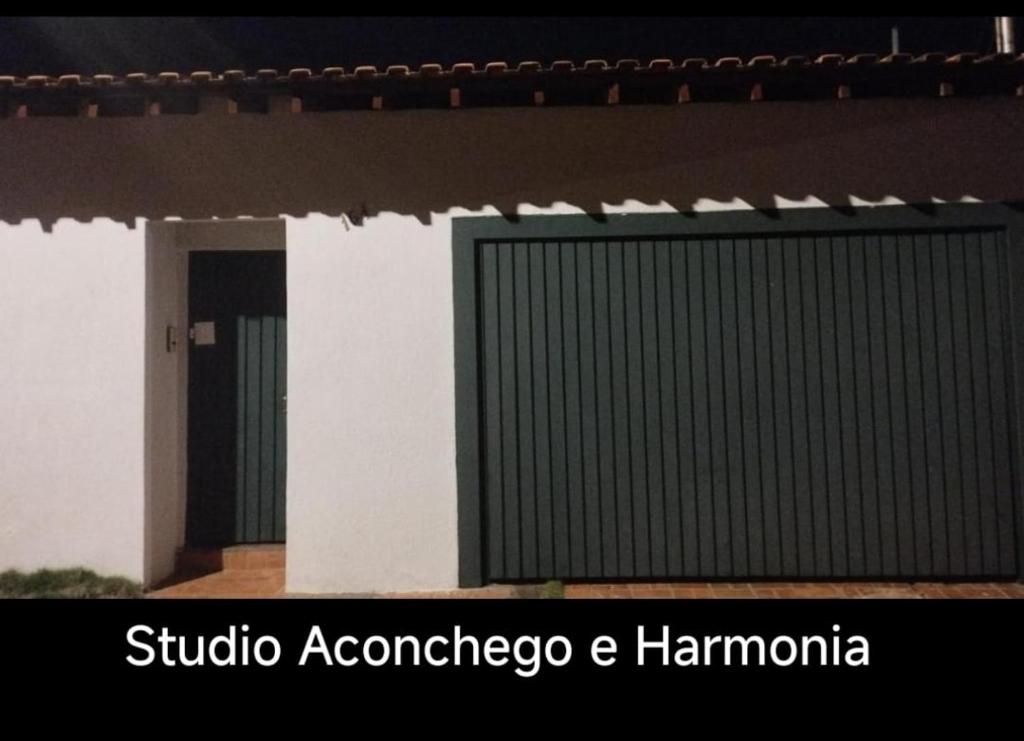 a building with a shutteraccoacco and hamomania on it at Kitnet Harmonia in Campo Grande