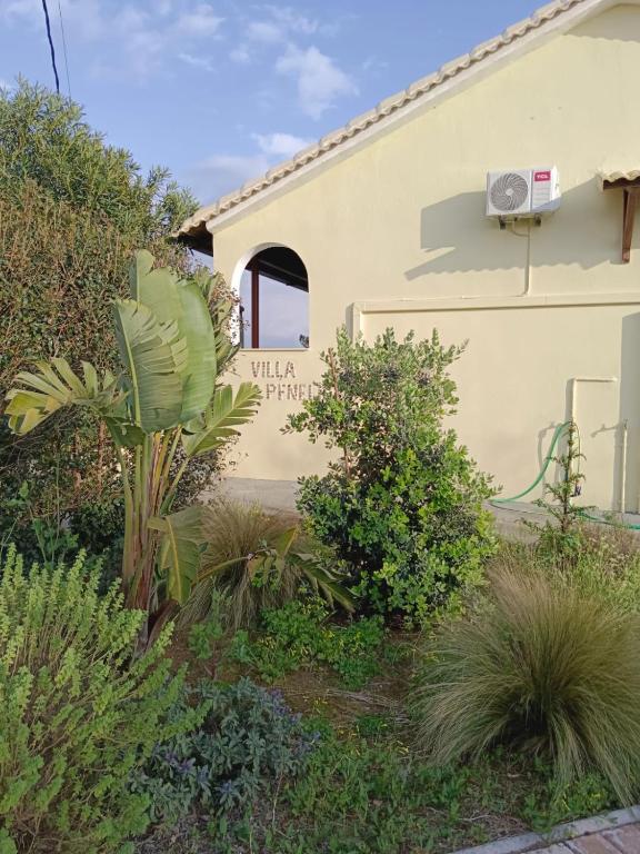 a house with a plant in front of it at Villa Penelia next to golf courses in Romanu