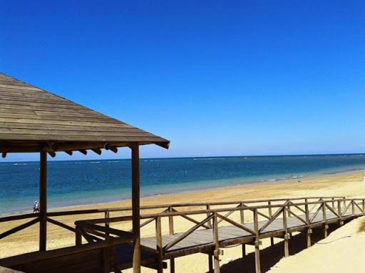 ロタにあるApartment Almadrabaの木造の桟橋と海のビーチ