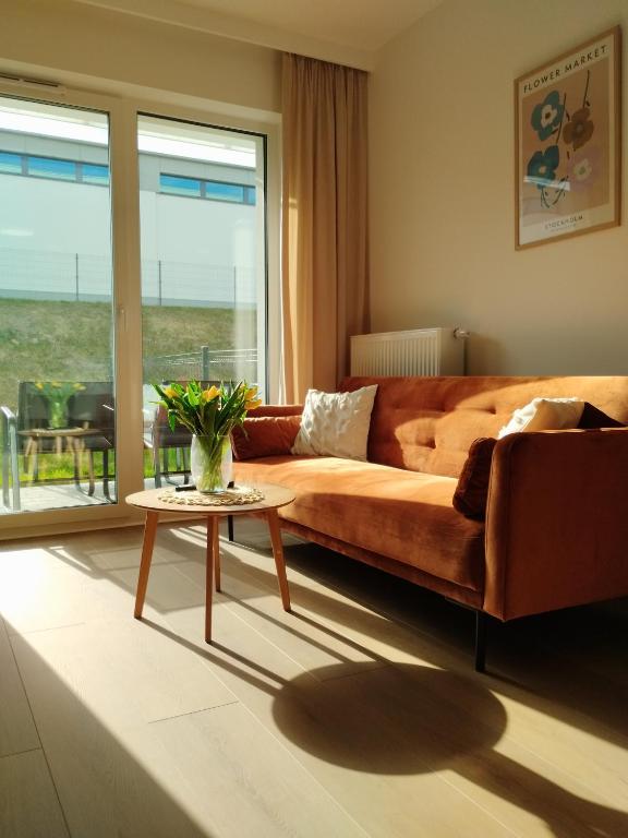 a living room with a couch and a table at Apartament MiA in Mrągowo