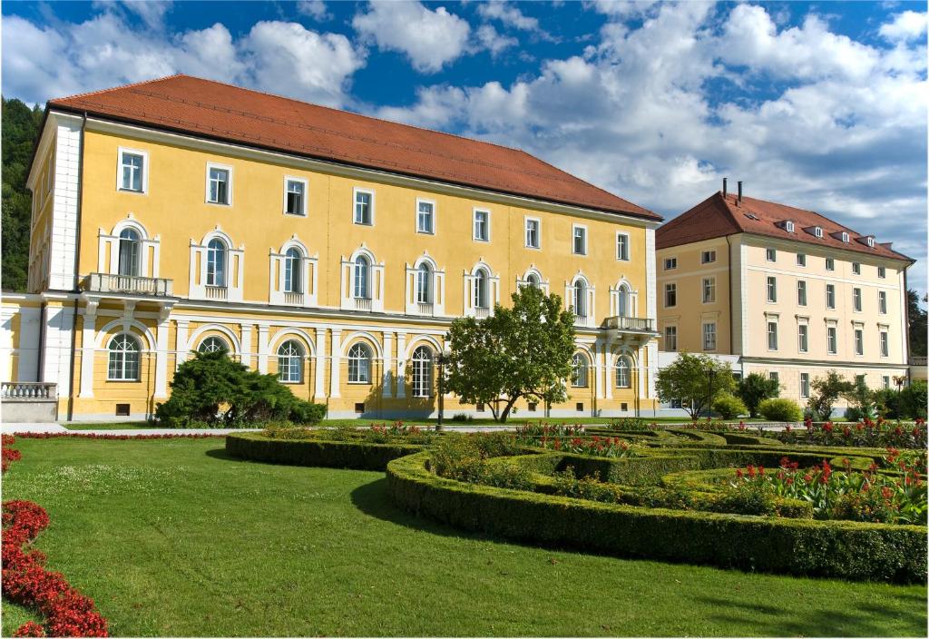 a large building with a clock on the front of it at Grand Hotel Rogaska in Rogaška Slatina