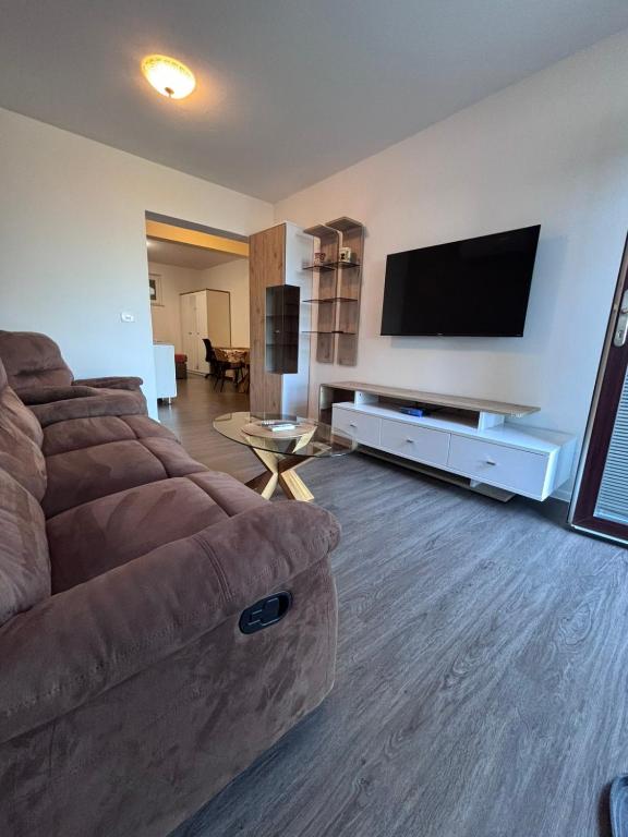 a living room with a couch and a flat screen tv at Ela in Žusterna