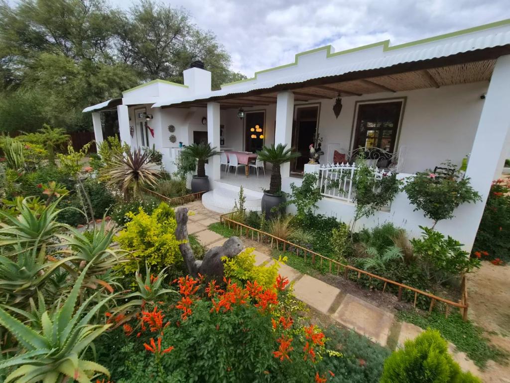 a house with flowers in front of it at Django's in Riebeek-Kasteel