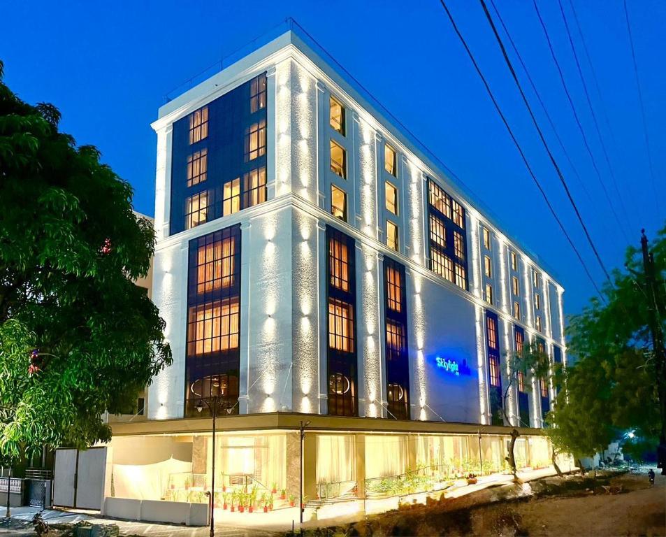 a large white building with lights on at SkkyLight Lords Inn Nanded in Nānded