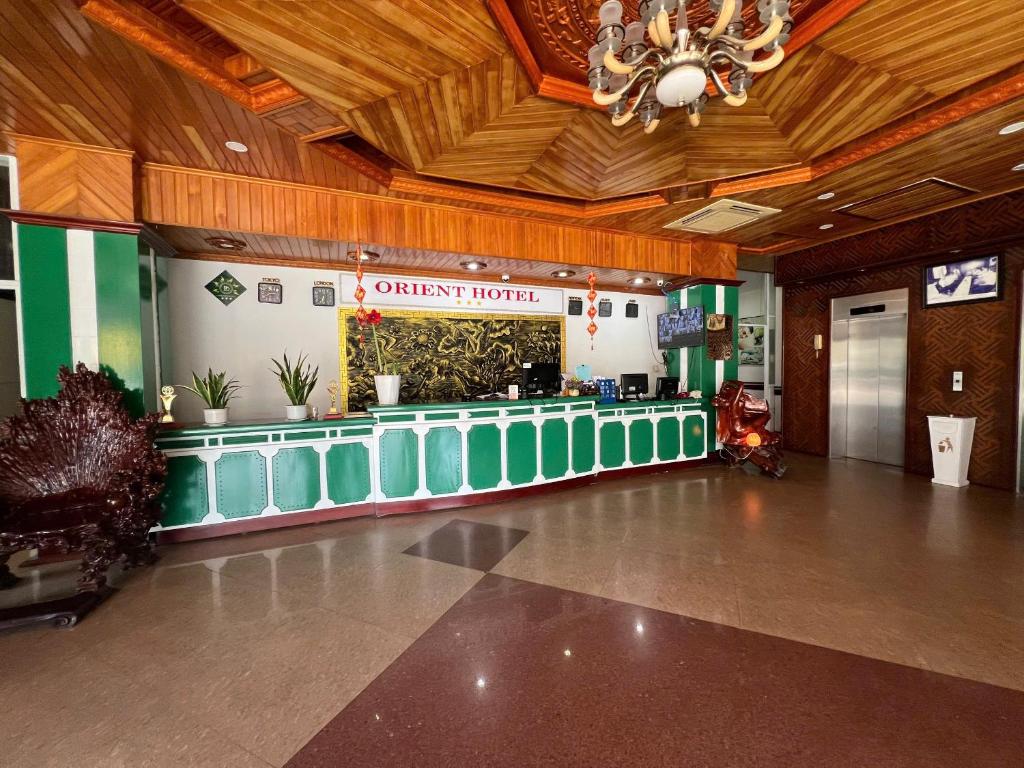 a lobby with a counter in the middle of a building at Center Orient Hotel in Danang