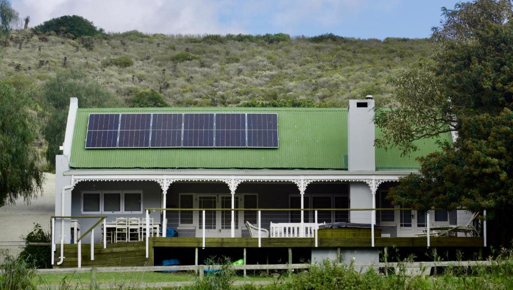 a house with a green roof with solar panels on it at Jonker's Cottage in Malgas