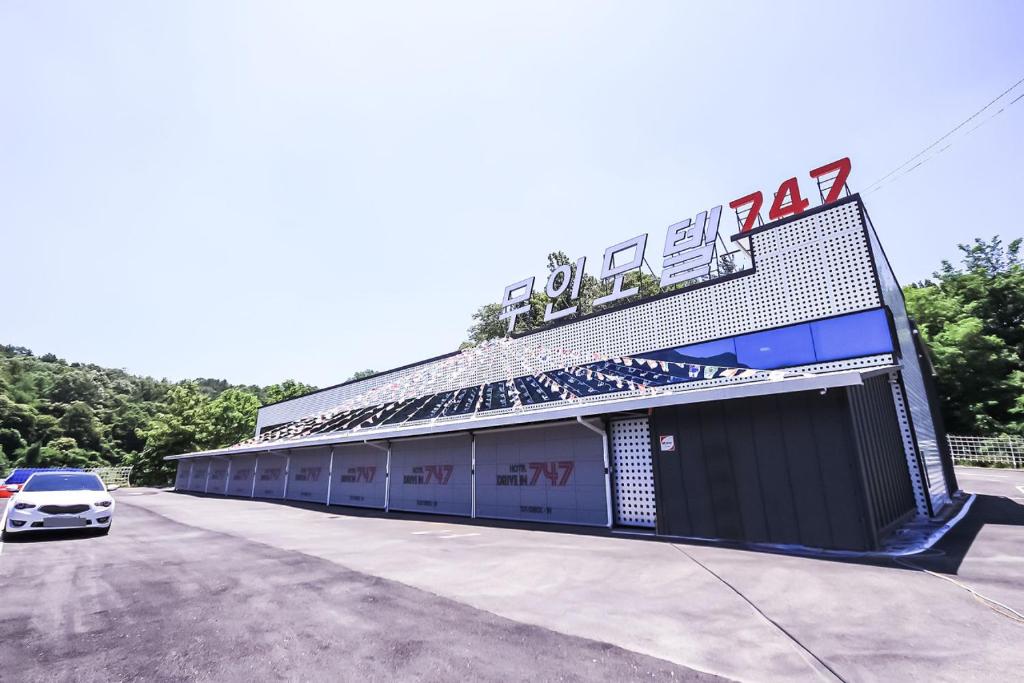 a building with a car parked in front of it at 747 Motel in Gimcheon