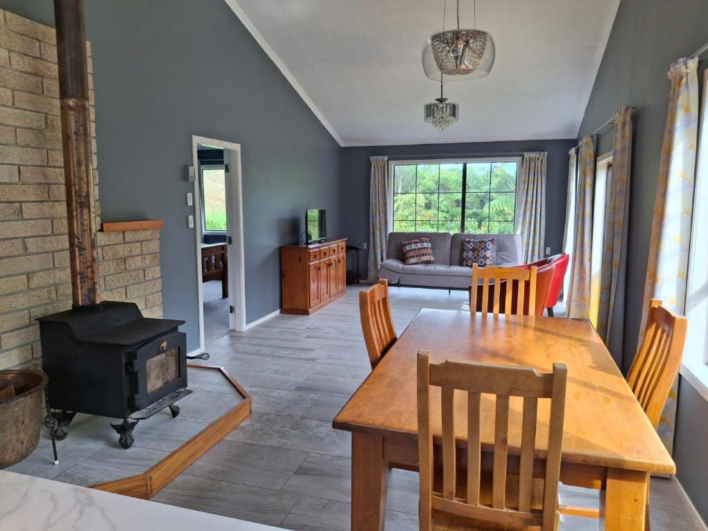 a living room with a table and a wood stove at Wheel Inn in New Plymouth