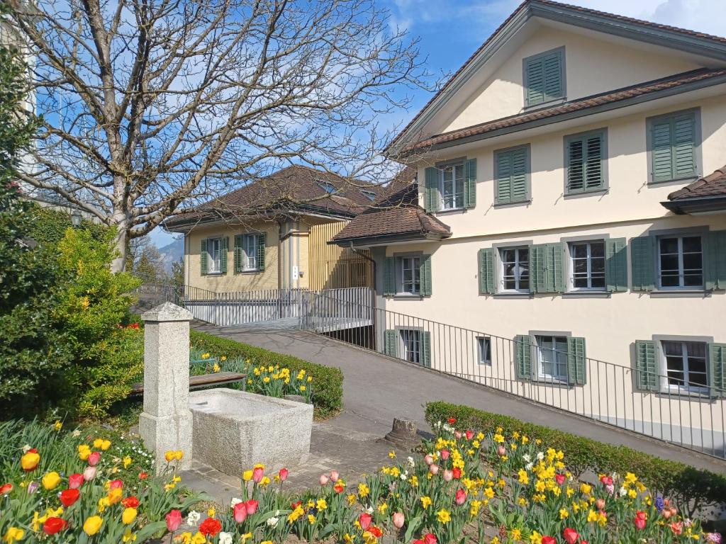 a house with flowers in front of it at Peterhof Sarnen in Sarnen