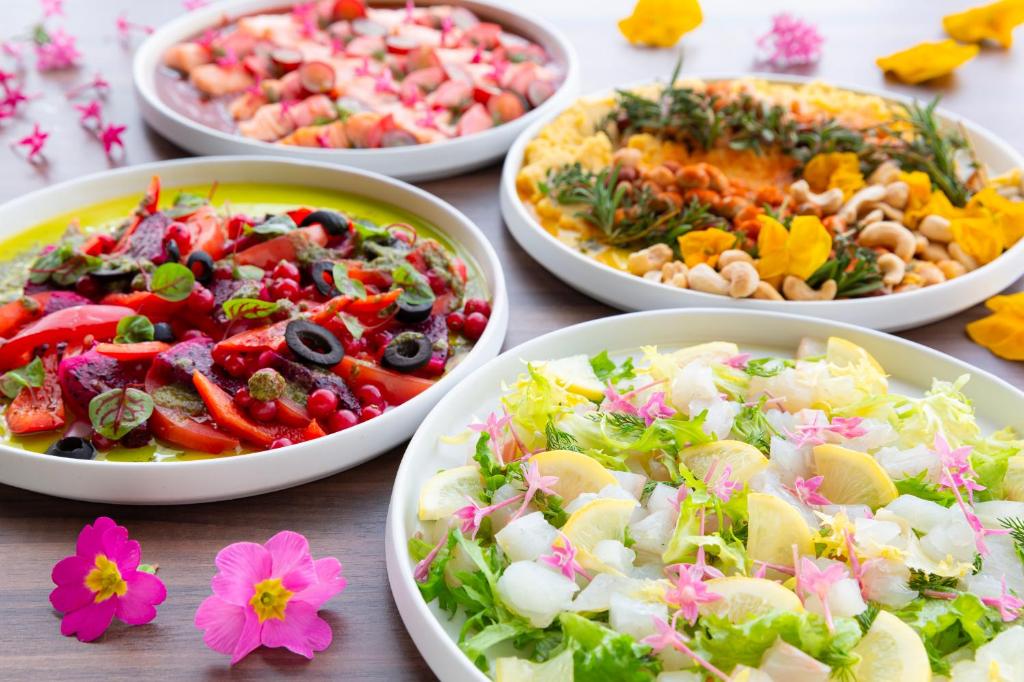 a table topped with bowls of different types of food at Hotel Keihan Kyoto Grande in Kyoto
