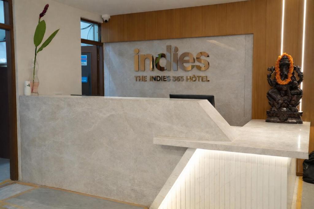 a lobby with a reception desk in a building at The Indies 365 Hotel in Bangalore
