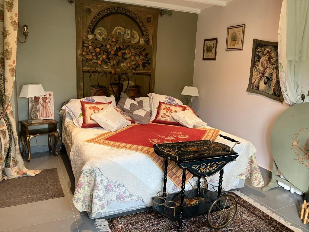a bedroom with a bed with a table on it at Une amazone en Provence in Paradou