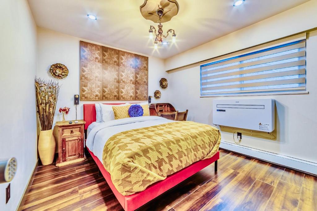 a bedroom with a bed and a television in it at Neocolonial Quarters in Vancouver