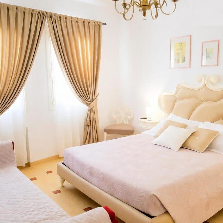 a bedroom with a large bed and a window at Suite Laguna in Chioggia